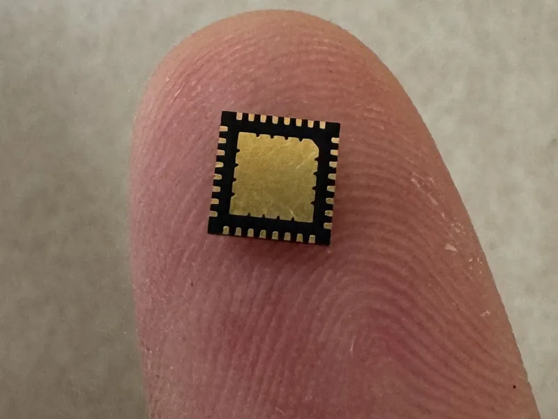 A custom ADC chip in a QFN32 package on a fingertip